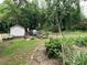Property featuring a shed, vintage truck, trailer, and landscaping at 198 Clouse Ln, Taylorsville, NC 28681
