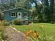 Charming cottage-style home with a well-maintained lawn and beautiful flowerbeds in a serene, wooded setting at 198 Clouse Ln, Taylorsville, NC 28681