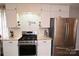 Well-lit kitchen features white cabinets, subway tile backsplash, and stainless steel appliances at 198 Clouse Ln, Taylorsville, NC 28681