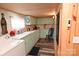 Efficient kitchen with vintage-style cabinetry, appliances, and wood paneling, offering a functional cooking space at 198 Clouse Ln, Taylorsville, NC 28681