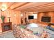 Cozy living room with wood-paneled walls, brick fireplace, decorative mantel, and comfortable seating at 198 Clouse Ln, Taylorsville, NC 28681
