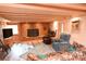 Inviting living room features a brick fireplace, wood paneled ceiling and accent wall, and comfortable seating area at 198 Clouse Ln, Taylorsville, NC 28681