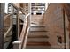 Unique wood staircase featuring natural branch-style railing, leading up to a bookshelf and accent wall at 198 Clouse Ln, Taylorsville, NC 28681