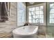 Relaxing bathroom with freestanding soaking tub and textured wall at 19906 Catamaran Ct, Cornelius, NC 28031