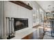 Modern fireplace with white textured surround and wooden mantel at 19906 Catamaran Ct, Cornelius, NC 28031