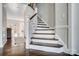 Elegant staircase with white railings and dark wood steps at 19906 Catamaran Ct, Cornelius, NC 28031