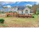 House back view, showcasing a large deck and backyard at 2044 Chameleon Rd, York, SC 29745