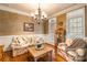 Sitting room with hardwood floors, chandelier, and floral furniture at 2044 Chameleon Rd, York, SC 29745