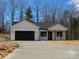 Newly built home with a black garage door and covered front porch at 2045 Cordia Cir, Newton, NC 28658