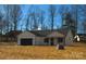 Modern farmhouse exterior with a black roof and attached garage at 2045 Cordia Cir, Newton, NC 28658