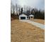 Newly constructed home with a white exterior, black garage door, and a covered porch at 2045 Cordia Cir, Newton, NC 28658