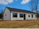 Rear view of a white house with black windows and a black door at 2045 Cordia Cir, Newton, NC 28658