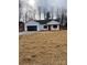 Newly constructed home with a white exterior, black garage door, and a covered porch at 2045 Cordia Cir, Newton, NC 28658