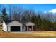 White house with black garage door and a long driveway at 2045 Cordia Cir, Newton, NC 28658