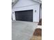 Modern black garage door on a newly built home at 2045 Cordia Cir, Newton, NC 28658