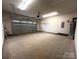 Attached garage with overhead door and ample space for storage at 2045 Cordia Cir, Newton, NC 28658