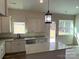 Kitchen with island, stainless steel appliances, white cabinets, and backyard access at 2045 Cordia Cir, Newton, NC 28658