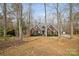 Traditional brick home with mature trees, and a separate garage nestled on a large lot at 2113 Sweet Clover Way, Denver, NC 28037