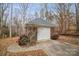 Detached brick garage with a white door and a landscaped area at 2113 Sweet Clover Way, Denver, NC 28037