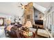 Spacious living room with a stone fireplace and leather furniture at 2113 Sweet Clover Way, Denver, NC 28037