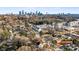 Aerial showcasing home, neighborhood, and distant city skyline at 2408 Rozzelles Ferry Rd, Charlotte, NC 28208