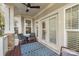 Covered back porch with seating and a ceiling fan at 2408 Rozzelles Ferry Rd, Charlotte, NC 28208