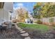 Backyard with fire pit, shed, and stone pathway at 2408 Rozzelles Ferry Rd, Charlotte, NC 28208