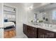 Double vanity bathroom with marble countertops and large shower at 2408 Rozzelles Ferry Rd, Charlotte, NC 28208