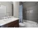 Clean bathroom with a shower/tub combo and marble vanity at 2408 Rozzelles Ferry Rd, Charlotte, NC 28208