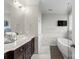 Bathroom with double vanity, marble, and a freestanding tub at 2408 Rozzelles Ferry Rd, Charlotte, NC 28208