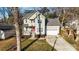 Two-story home with gray siding, red door, and attached garage at 2408 Rozzelles Ferry Rd, Charlotte, NC 28208