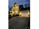 Two-story home exterior at night, showcasing lighting and garage at 2408 Rozzelles Ferry Rd, Charlotte, NC 28208