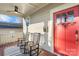 Inviting front porch with rocking chairs, red door entry, and decorative rug at 2408 Rozzelles Ferry Rd, Charlotte, NC 28208