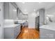 Modern kitchen with gray cabinets, stainless steel appliances, and hardwood floors at 2408 Rozzelles Ferry Rd, Charlotte, NC 28208