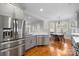 Eat-in kitchen with stainless steel appliances and hardwood floors at 2408 Rozzelles Ferry Rd, Charlotte, NC 28208