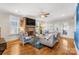 Bright living room with hardwood floors, stone fireplace, and access to backyard at 2408 Rozzelles Ferry Rd, Charlotte, NC 28208