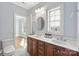 Bathroom featuring a double vanity, framed mirror, and bright natural light from a large window at 2907 Cutter Ct, Waxhaw, NC 28173