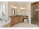 Bright bathroom with a soaking tub, double vanity, granite countertops and walk-in shower at 2907 Cutter Ct, Waxhaw, NC 28173