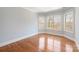 Well-lit bedroom with hardwood floors, crown molding, and large windows overlooking the property at 2907 Cutter Ct, Waxhaw, NC 28173