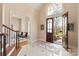 Grand foyer with tiled flooring, staircase, and arched doorway leading to a living area at 2907 Cutter Ct, Waxhaw, NC 28173