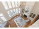 Bright living room with large windows, hardwood floors, chandelier, and cozy fireplace at 2907 Cutter Ct, Waxhaw, NC 28173