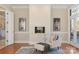 Elegant living room featuring a tiled fireplace, hardwood floors, and bright natural light at 2907 Cutter Ct, Waxhaw, NC 28173