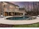 Beautiful backyard pool with stone accents, patio, and an attached deck, ideal for entertaining at 2907 Cutter Ct, Waxhaw, NC 28173