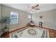 Sunlit bedroom featuring hardwood floors and three windows at 2935 Dairy Farm Dr, Monroe, NC 28110