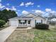 Charming single-story home featuring a welcoming front porch and attached one car garage at 2935 Dairy Farm Dr, Monroe, NC 28110