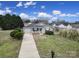 Inviting home featuring a covered porch and a well-manicured front yard at 2935 Dairy Farm Dr, Monroe, NC 28110