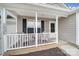 Inviting front porch with white railings, seating and charming details at 2935 Dairy Farm Dr, Monroe, NC 28110