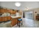 Eat-in kitchen featuring wooden cabinets and a center island with stool seating at 2935 Dairy Farm Dr, Monroe, NC 28110