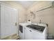 Laundry room includes a dryer, washing machine and shelving at 2935 Dairy Farm Dr, Monroe, NC 28110