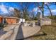 Large brick patio with stone fireplace and seating area at 3019 Parkstone Dr, Charlotte, NC 28210